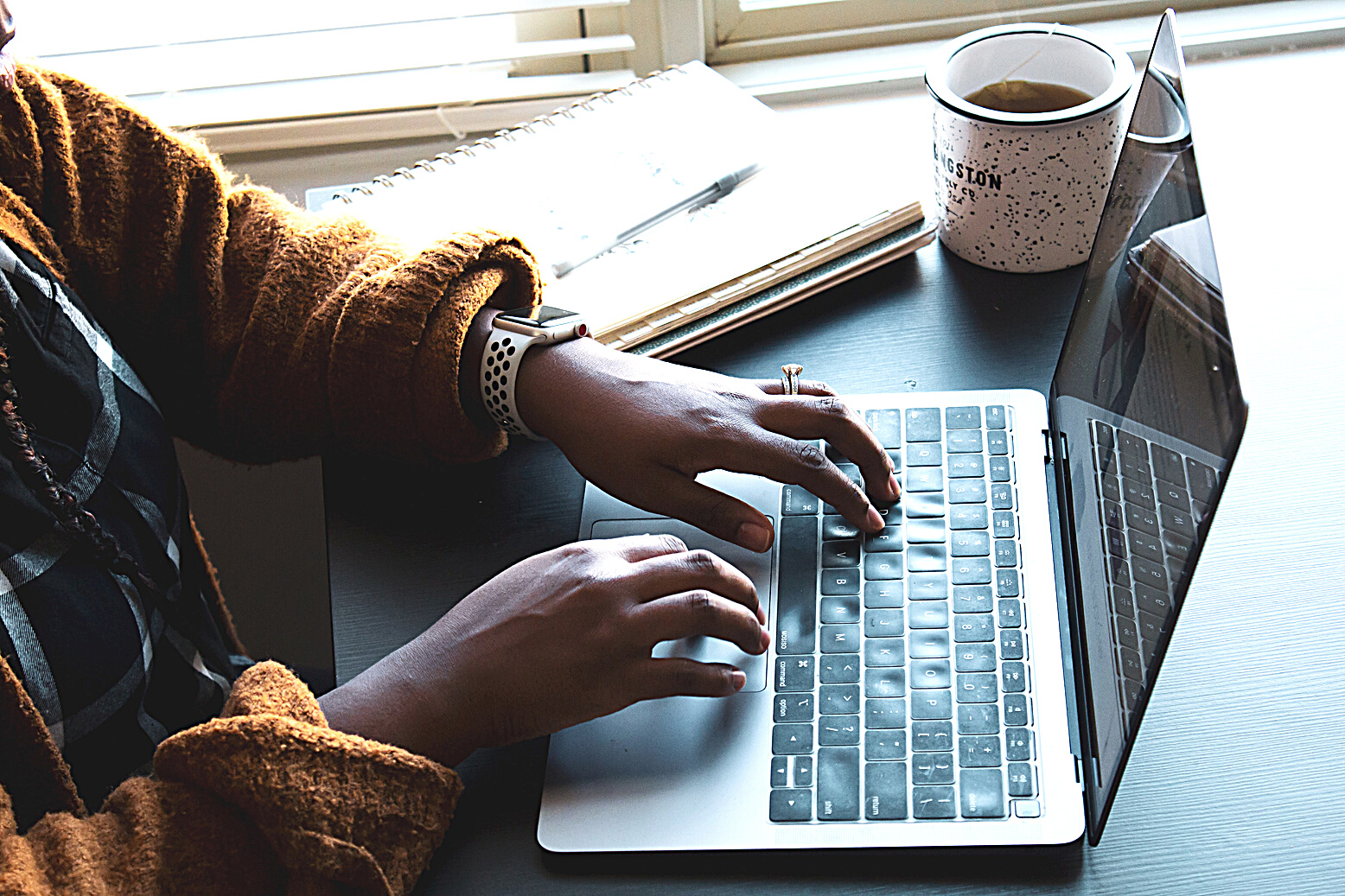 A Person Typing on a Laptop